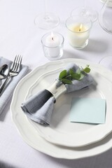 Beautiful table setting with card and floral decor