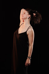 Naklejka premium brunette woman posing in black studio