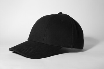 Stylish black baseball cap on white background