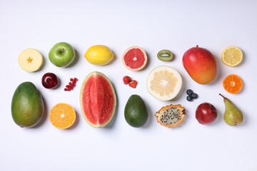 Different ripe fruits and berries on white background, top view