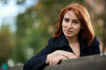 Close-up Portrait of Stylish Redhead Woman in Urban Autumn Fashion