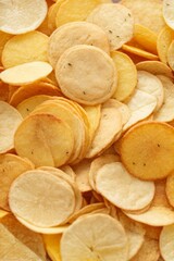Top view close-up of golden yellow delicious chips texture. Food, Fast food.