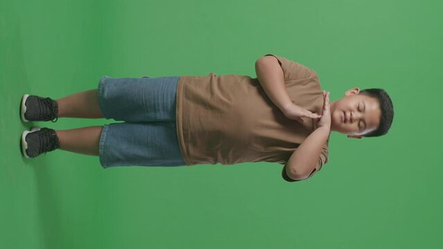Full Body Of Asian Man Doing Time Out Gesture With Hands While Standing On The Green Screen
