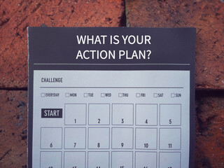 Management and motivational word. WHAT IS YOUR ACTION PLAN written on a book planner. With blurred styled background.