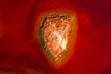 Detail of the heart-shaped rocky bottom of the Rio Tinto in Huelva (Spain). The red colour of the...