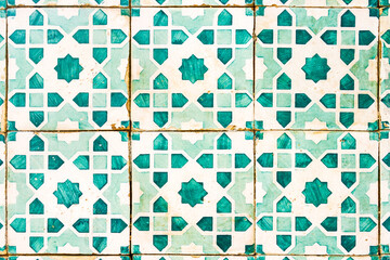 Antique tiles with green geometrical motifs on a white background (Lisbon)