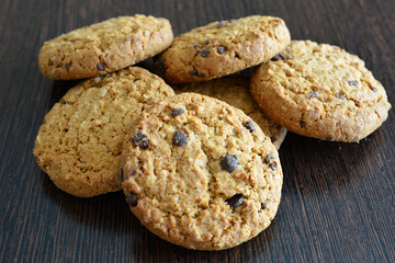 wholegrain cookies with chocolate chips isolated on dark wooden background   