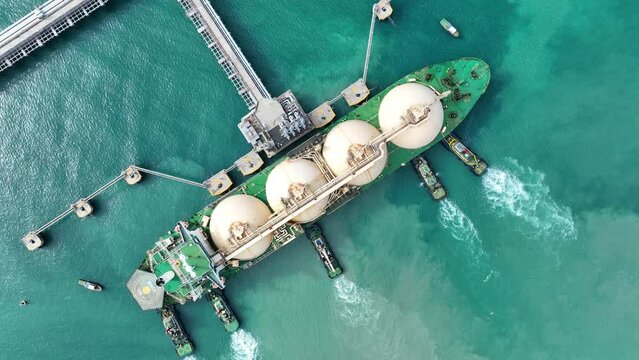 LNG (Liquified Natural Gas) tanker anchored in Gas terminal gas tanks for storage. Oil Crude Gas Tanker Ship. LPG at Tanker Bay Petroleum Chemical or Methane freighter export import	
