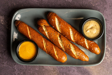 Soft pretzels with mustard and cheese sauce