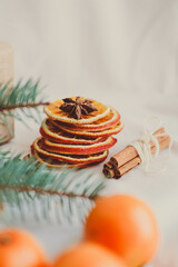 Christmas decoration with fir branches, dried orange slices, cinnamon and anise on white background