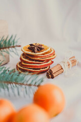 Christmas decoration with fir branches, dried orange slices, cinnamon and anise on white background