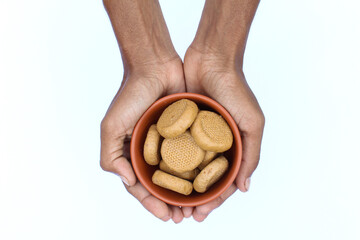 Holding some Indian sweet peda or Pera in a hand top view 