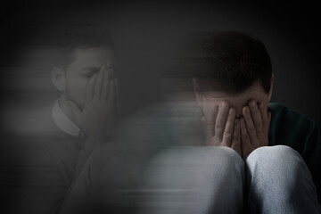 Man suffering from mental illness on dark background. Dissociative identity disorder