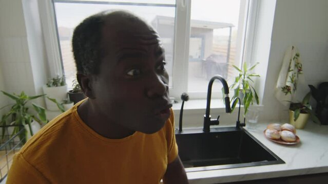 African American husband shouting at somebody at home