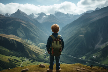 A hiker boy walking on a mountain valley in spring. Hiking in the Caucasian mountains. Boy with Backpack on top of a mountain cliff landscape. Adventure Concept, Travel - obrazy, fototapety, plakaty