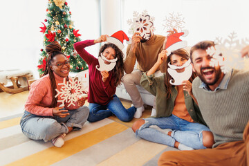 Friends making Christmas decorations out of paper