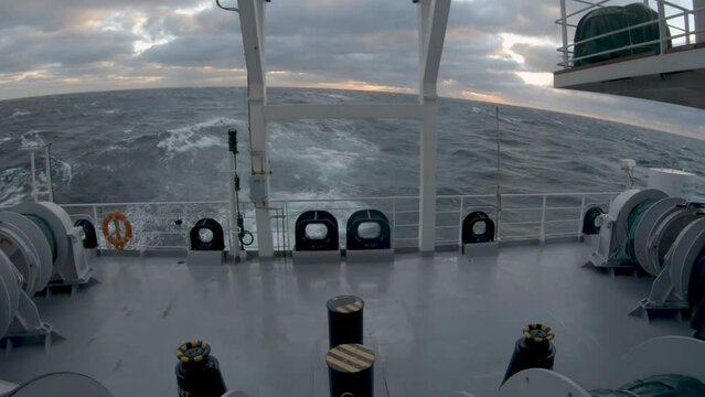 Storm. Sea. Stern of ship in storm. Splashes of water fly up. Strong pitching.