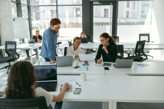 Group of diverse people discussing new project in office meeting room. Business teamwork situation