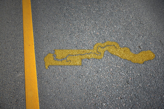 yellow map of gambia country on asphalt road near yellow line.