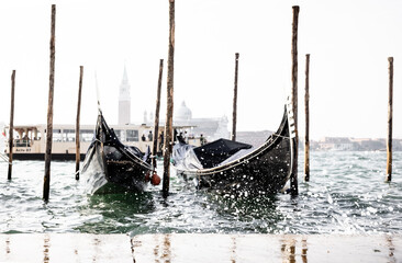 high waves splashing along gondolas in Venice Italy
