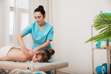 A massage therapist gives a massage to a client in the Osteopathy Health office