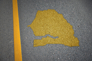 yellow map of senegal country on asphalt road near yellow line.