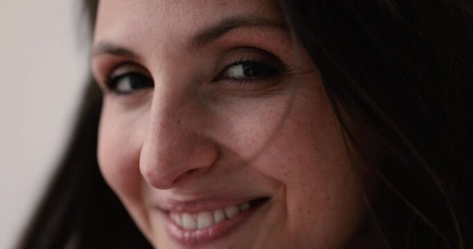 Happy woman with windswept hair smiling at camera