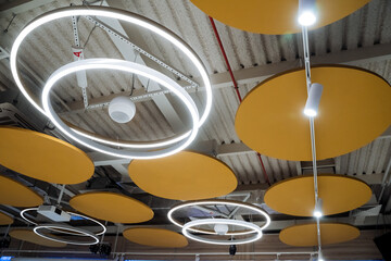 Round lamp hanging in conference room, large room interior lighting, LED lamp.