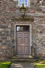 Fototapeta na wymiar Old Georgian stone townhouse door with fanlight window above door