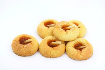 Thumbprint cookies with apricot jam and almonds, white background