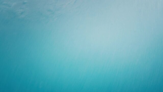 Surfer rides the ocean wave during overcast rainy day