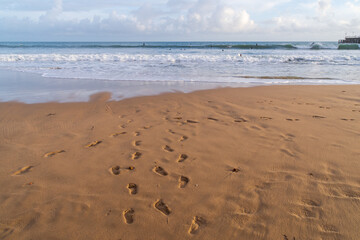 Footprints in the wet sand on Bournemouth East Beach, UK