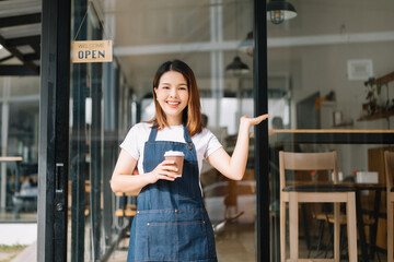 Woman coffee shop owner holding notepad and digital tablet ready to receive orders in cafe restaurant.