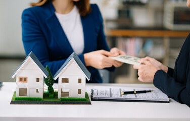 balancing the property sector The real estate agent is explaining the house style to see the house...