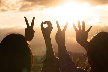 Obraz premium Raised hand with 2024 symbol, Happy New Year 2024, hand with beautiful sunset.