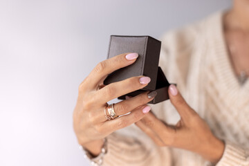 "Cherished Moments: Hands Holding a Thoughtful Jewellery Gift"