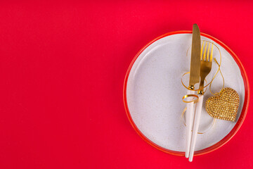 Valentine day  table setting background table setting for romantic dinner on red background, top view. Valentine's day celebration menu, greeting card or invitation background, Galentine day flat lay