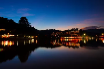Foto op Canvas Mae Hong Son / Thailand - October 31 2021: Baan Rak Thai Village Light from lamps reflecting on the River Sunset Twilight. © Craita