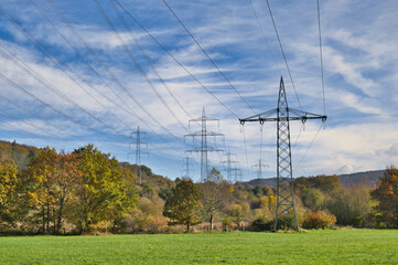 Overhead power pylons, power lines in a colorful autumnal landscape