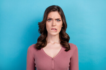 Photo of gloomy angry dissatisfied woman with wavy hairdo dressed pink cardigan biting lips staring...
