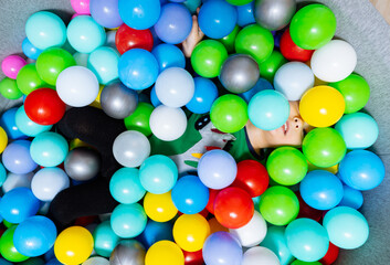 A Festive Bucket Overflowing With Vibrant, Multicolored Balloons. A bucket filled with lots of colorful balloons