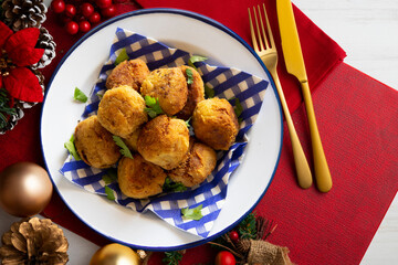 Vegan meatballs made with chickpeas and flour. Christmas food served on a table decorated with Christmas motifs.