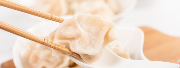 Fresh, delicious boiled pork, shrimp gyoza dumplings on white background with soy sauce and...