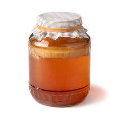 Glass jar with a Kombucha tea mushroom, scoby to produce Kombucha drink isolated on white background close up