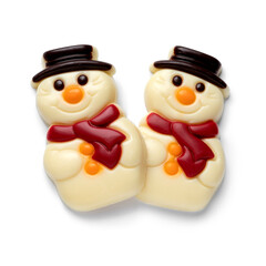 Pair of happy white chocolate snowmen isolated on white background close up