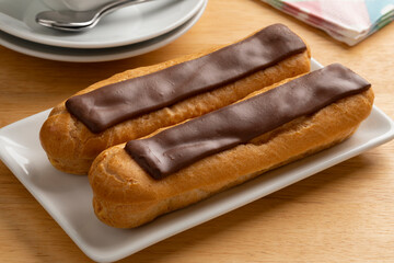 Pair of  traditional French eclair on a plate close up