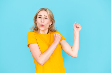 Young woman in yellow t-shirt dancing on party