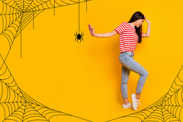 Photo collage of funny young woman scared showing stop gesture hand against hanging spider on web...