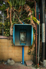 an abandoned public telephone on the side of the road