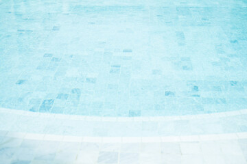 Clear blue water in the pool, curved swimming pool. Step into the water and finish the pool bottom...